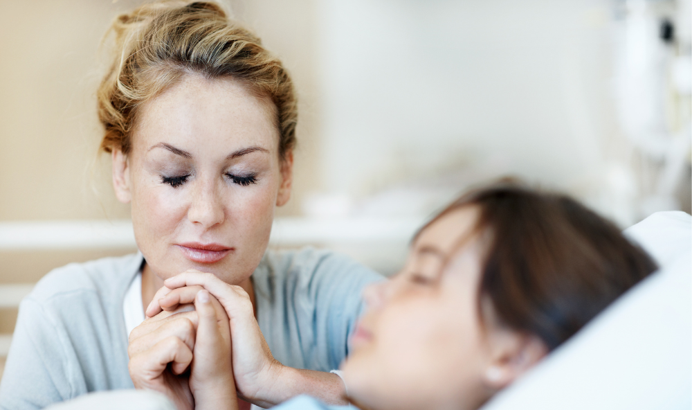 mother praying with daughter