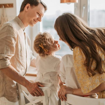 Happy family bonding in a bright kitchen setting, embracing love and togetherness.